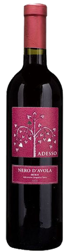 A bordelaise shaped wine bottle with red wine inside. A reddish brick colour foil top on the bottle. The front label is brick red in colour with a silver tree and branches with heart shaper leaves. Text in silver of ADESSO and NERO D'AVOLA. Sicily. The back label reads Product of Italy 75cl 14% alc %