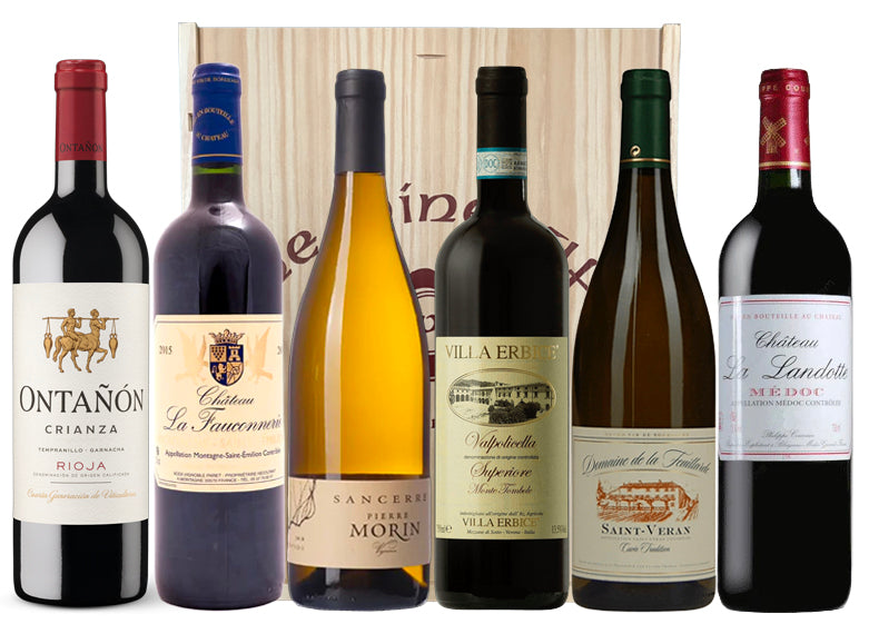 Six classic bottles of wine with labels in front of a wooden wine gift box.