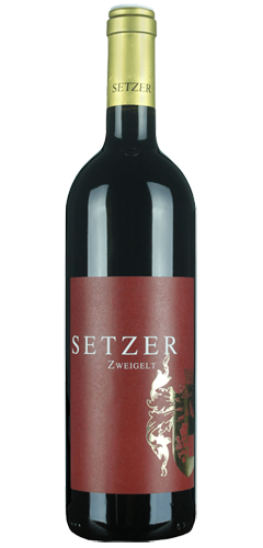 A green bordeaux shaped wine bottle of red wine, with a gold foil top on the bottle and a dark red label with a gold crest of arms picture and text in gold of SETZER ZWEIGELT.
