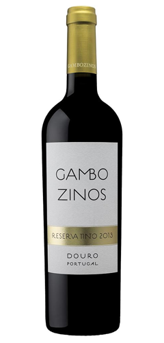 brown wine bottle with red wine inside, gold capsule on the neck of the bottle and a white label with the text GAMBOZINOS, RESERVA TINTO, DOURO, PORTUGAL